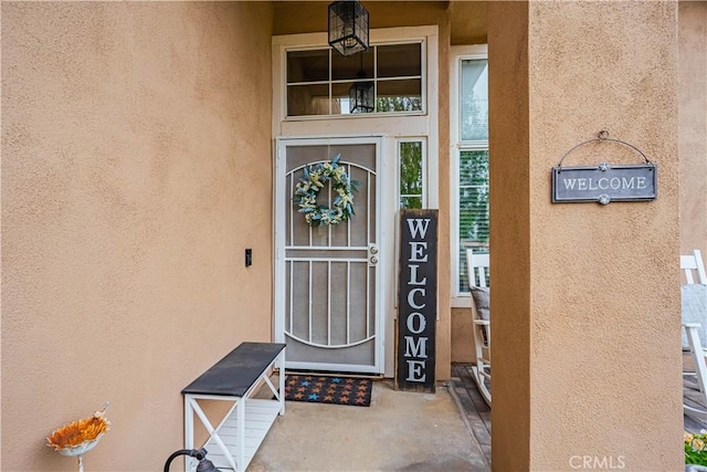 view of exterior entry with stucco siding