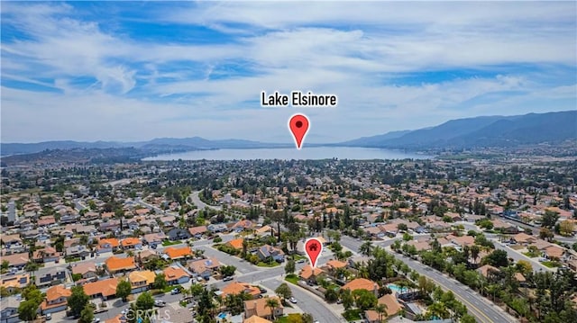 drone / aerial view featuring a water and mountain view and a residential view
