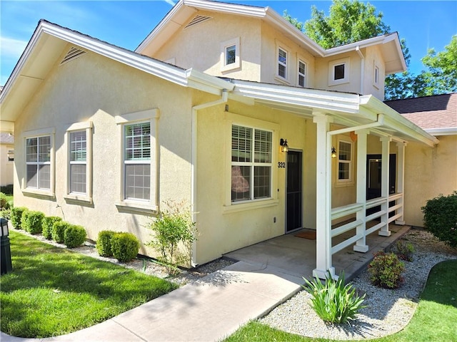 view of front of house featuring a porch and stucco siding