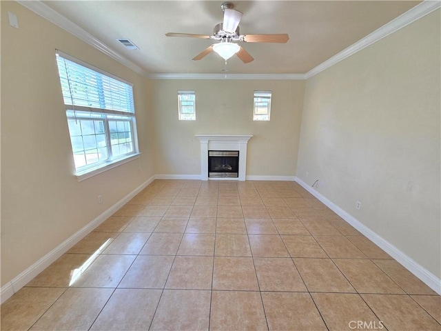 unfurnished living room featuring a ceiling fan, light tile patterned floors, baseboards, ornamental molding, and a fireplace