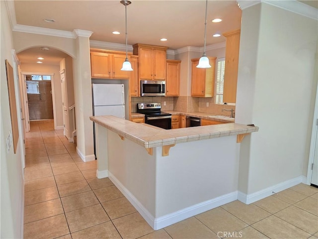 kitchen with arched walkways, stainless steel appliances, light tile patterned floors, and tasteful backsplash
