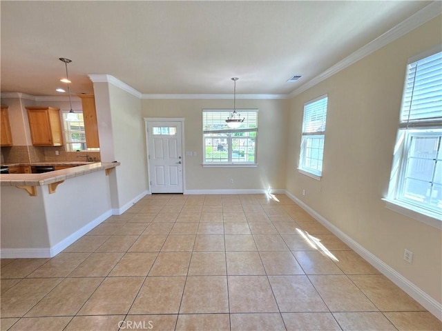 unfurnished dining area with ornamental molding, baseboards, light tile patterned floors, and recessed lighting