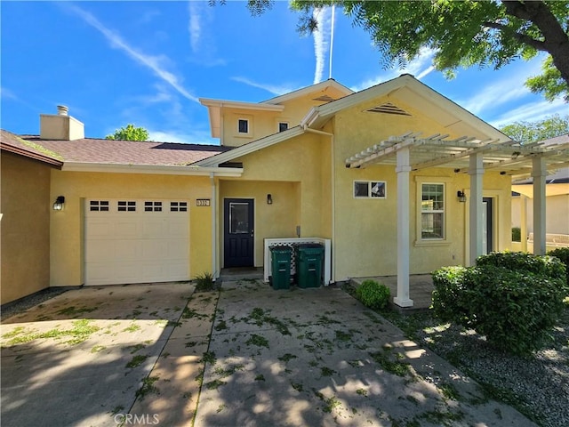view of front of house featuring an attached garage, concrete driveway, stucco siding, a pergola, and a chimney