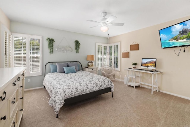 bedroom with baseboards, ceiling fan, and light colored carpet