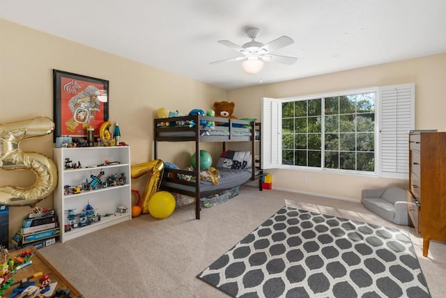 carpeted bedroom featuring baseboards and ceiling fan