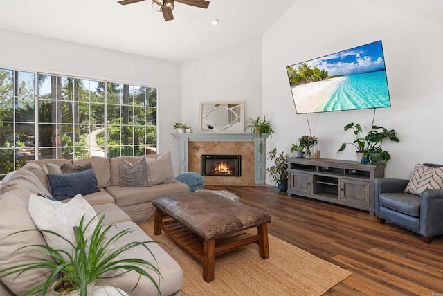 living room featuring a fireplace, ceiling fan, lofted ceiling, and wood finished floors