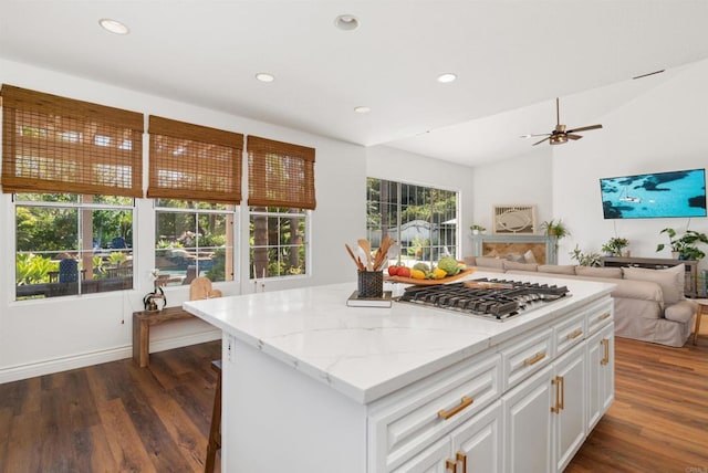 kitchen featuring white cabinetry, light stone counters, dark wood finished floors, and recessed lighting