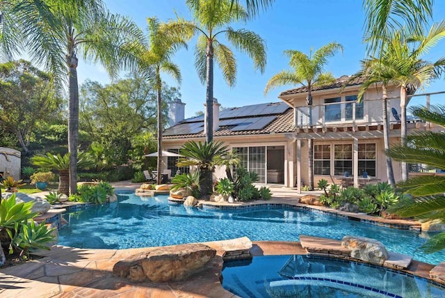 view of pool featuring a patio area and a pool with connected hot tub