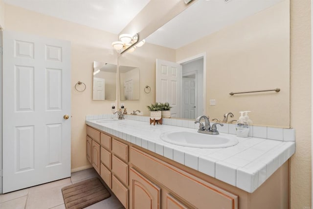 bathroom with tile patterned flooring, double vanity, and a sink