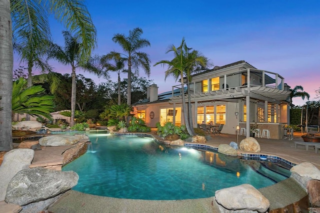 pool at dusk with a pergola, an outdoor pool, and a patio