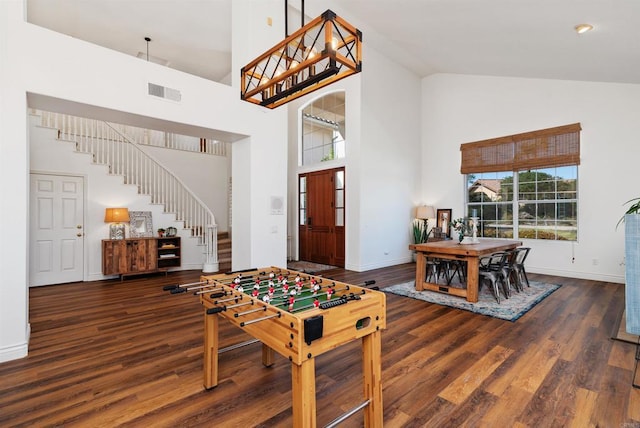 playroom featuring visible vents, wood finished floors, baseboards, and high vaulted ceiling
