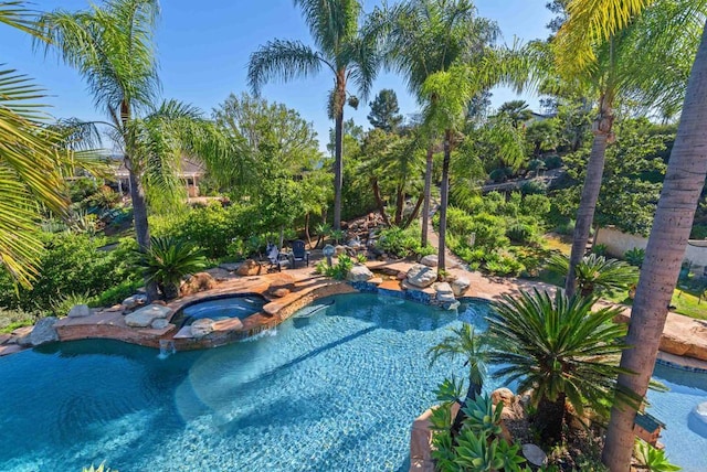 view of pool with a pool with connected hot tub