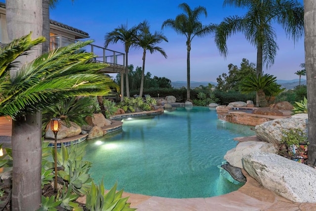pool at dusk featuring an outdoor pool