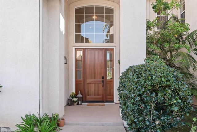property entrance with stucco siding