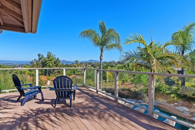 wooden deck featuring a mountain view
