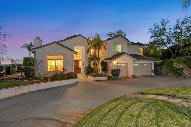 mediterranean / spanish-style home featuring fence, driveway, a garage, stucco siding, and a chimney