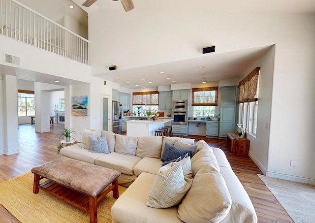 2034 Ridgecrest Pl, Escondido, CA 92029 - living area featuring baseboards, a ceiling fan, light wood finished floors, and a high ceiling