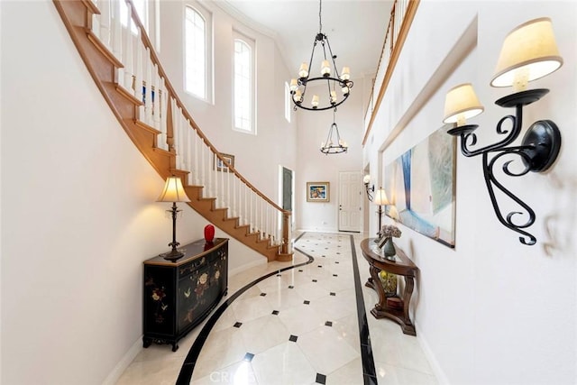 6312 Camino Marinero, San Clemente, CA 92673 - foyer entrance with a chandelier, tile patterned flooring, stairs, a towering ceiling, and inlaid floor details