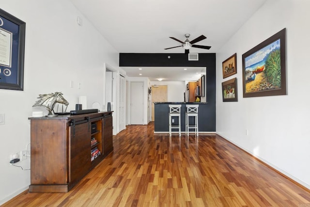 350 11th Ave Unit 928, San Diego, CA 92101 - living room with baseboards, a ceiling fan, visible vents, and wood finished floors