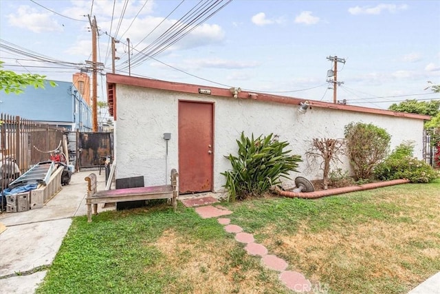 view of outbuilding featuring fence
