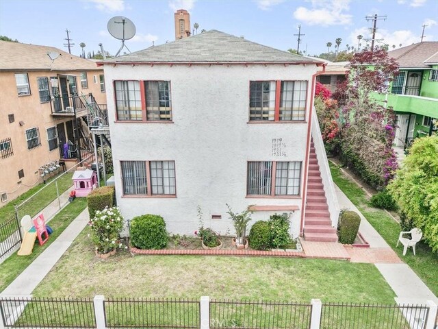 1919 W 35th St, Los Angeles, CA 90018 - view of front of property featuring stairway, stucco siding, and a shingled roof