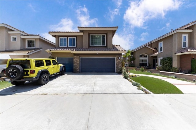 5530 Van Gogh Way, Yorba Linda, CA 92887 - view of front facade featuring a tile roof, an attached garage, concrete driveway, stucco siding, and brick siding