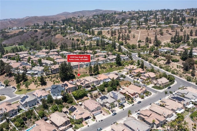 5530 Van Gogh Way, Yorba Linda, CA 92887 - aerial view of property's location with a mountainous background and nearby suburban area