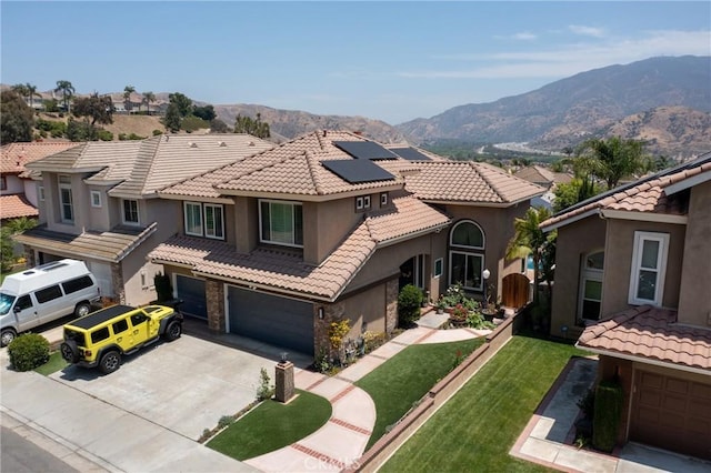 5530 Van Gogh Way, Yorba Linda, CA 92887 - mediterranean / spanish-style house with roof mounted solar panels, a garage, a mountain view, a tiled roof, and a front yard