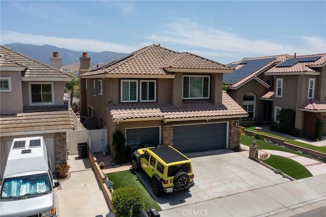 5530 Van Gogh Way, Yorba Linda, CA 92887 - view of front facade featuring a tiled roof, a garage, concrete driveway, stucco siding, and a mountain view