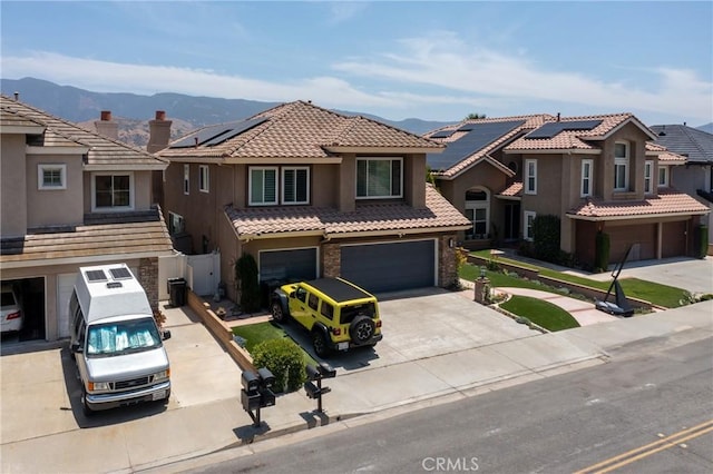 5530 Van Gogh Way, Yorba Linda, CA 92887 - view of front facade with an attached garage, concrete driveway, stucco siding, a mountain view, and a tile roof
