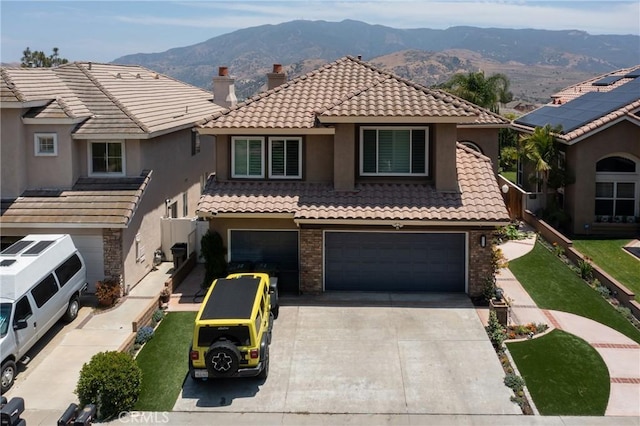 5530 Van Gogh Way, Yorba Linda, CA 92887 - mediterranean / spanish home with an attached garage, a mountain view, a tile roof, concrete driveway, and brick siding