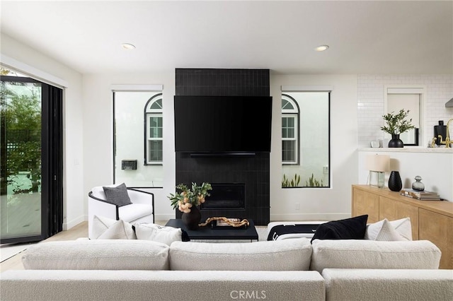 living room featuring a fireplace and recessed lighting