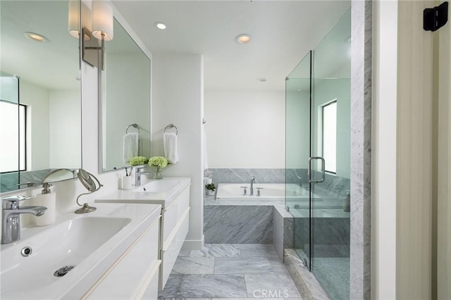 bathroom featuring a sink, a garden tub, a shower stall, and marble finish floor