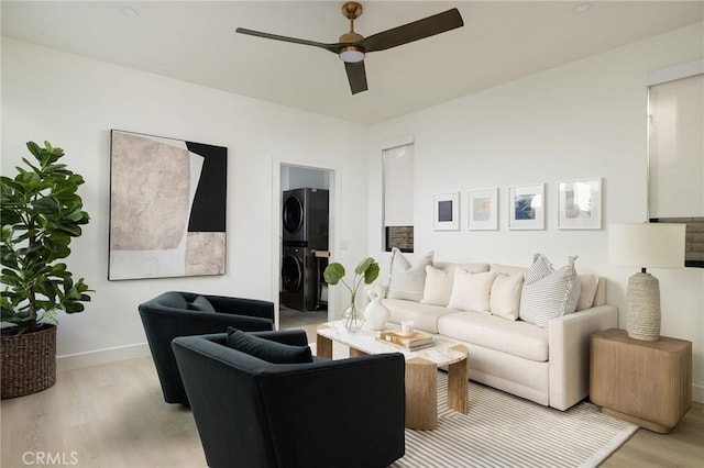 502 Jasmine Ave Unit A, Corona Del Mar, CA 92625 - living room featuring stacked washer / dryer, light wood-type flooring, ceiling fan, and baseboards