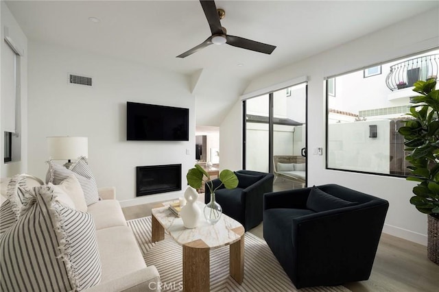 502 Jasmine Ave Unit A, Corona Del Mar, CA 92625 - living area featuring wood finished floors, a fireplace, a ceiling fan, baseboards, and vaulted ceiling