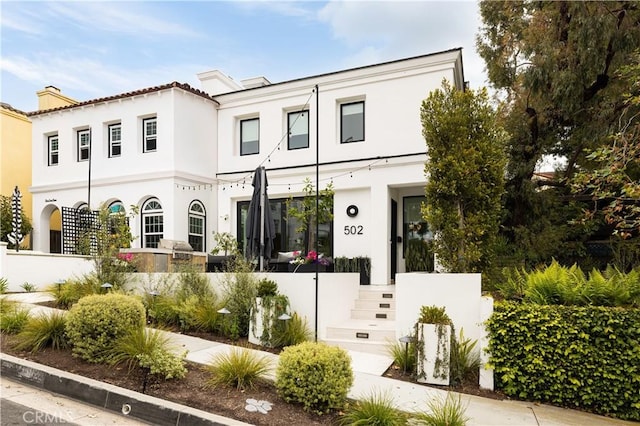 502 Jasmine Ave Unit A, Corona Del Mar, CA 92625 - view of front of home with stucco siding and a chimney