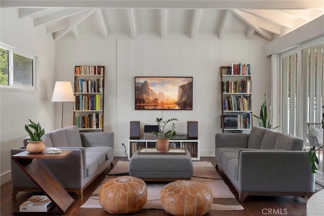 living area featuring wood finished floors and beamed ceiling