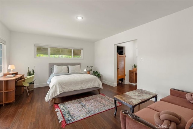 bedroom with multiple windows, wood finished floors, baseboards, and recessed lighting