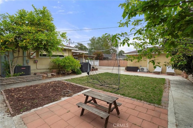 exterior space featuring central AC unit, a patio area, and fence