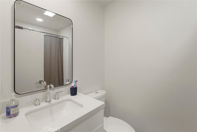 bathroom featuring toilet and vanity