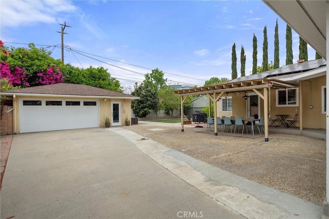 view of yard with an outdoor structure, a garage, outdoor dining area, and a patio area