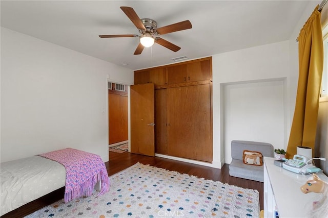 bedroom featuring a closet, visible vents, wood finished floors, and ceiling fan