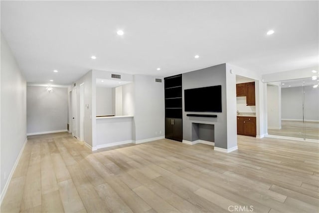 unfurnished living room with baseboards, recessed lighting, light wood-style floors, and visible vents