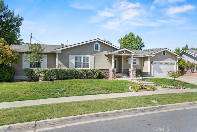 view of front of house featuring concrete driveway, a front yard, and an attached garage