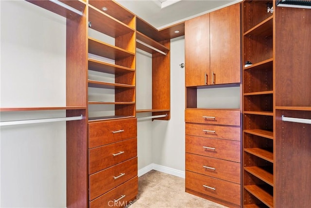 walk in closet featuring light tile patterned flooring