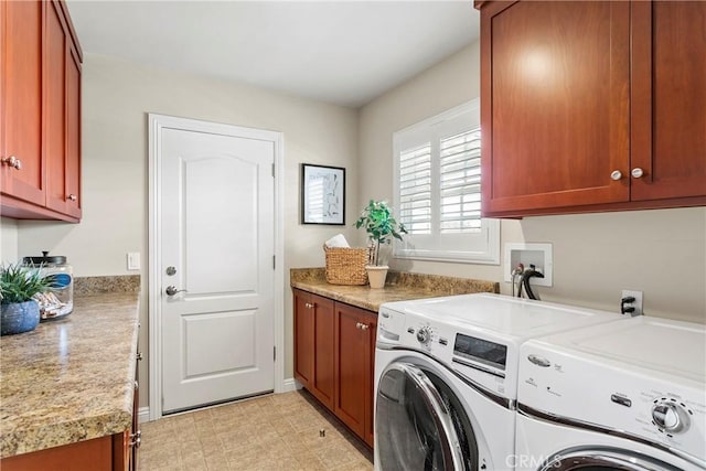 washroom featuring light floors, cabinet space, and washer and clothes dryer