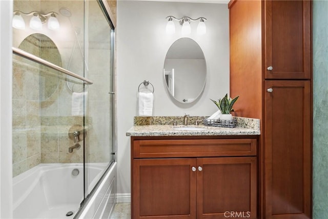 full bathroom featuring vanity and shower / bath combination with glass door