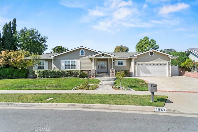 ranch-style home with fence, stone siding, driveway, a garage, and a front lawn