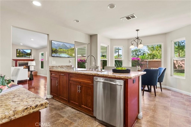 kitchen with a sink, visible vents, recessed lighting, dishwasher, and a lit fireplace