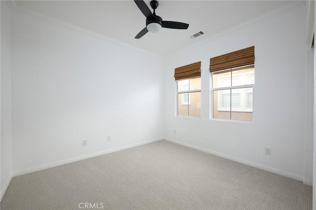 unfurnished room with crown molding, visible vents, baseboards, and light carpet